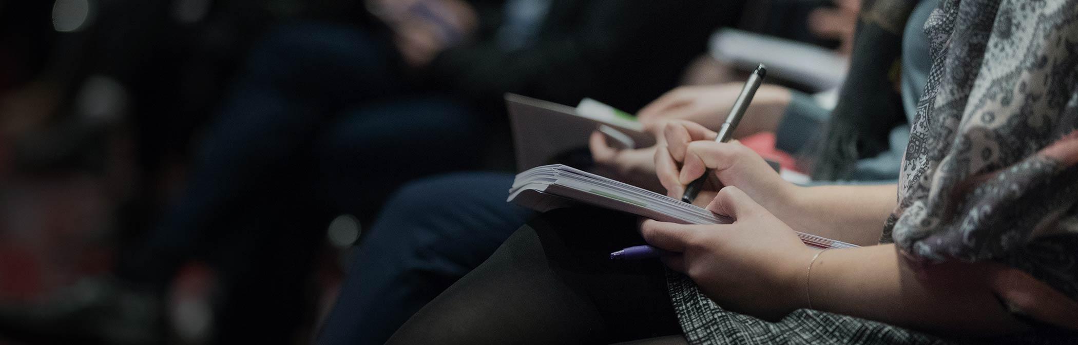 Student Taking Notes In Class